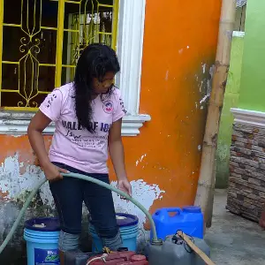 woman fills up container